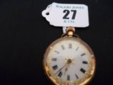A lady`s bright cut fourteen carat gold encased fob watch with white enamel dial and Roman