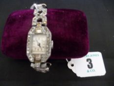 A lady`s oblong dial marcasite decorated cocktail watch with marcasite shoulders and leather and