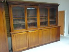 A large mahogany four door bookcase cupboard (from a Vale of Glamorgan solicitor’s office) with four