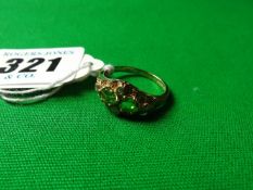 A nine carat gold dress ring with two peridots and tiny diamonds.