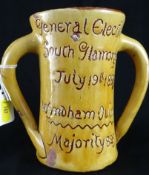 Ewenny Pottery; a yellow glazed mug commemorating the General Election victory of Wyndham Quin, July