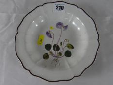 Swansea Porcelain; an early 19th Century creamware six lobed dish having a chocolate coloured edge