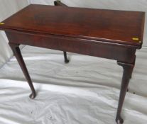A mid 18th Century oblong topped mahogany foldover card table having a baize lined interior on