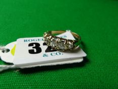 An eighteen carat gold oblong set five stone dress ring.