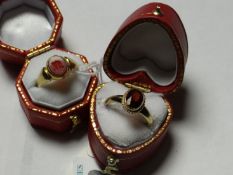 A nine carat gold oval garnet dress ring and a nine carat gold red seal signet ring.