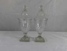 A pair of late 18th Century Waterford glass comfitures having domed covers over vase shaped bodies