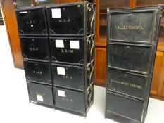 A metal rack containing six black metal, lockable deed boxes, labelled in alphabetical order, eg