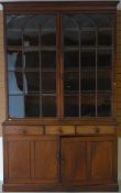 An early 19th Century mahogany bookcase, the upper portion having two glazed doors with shaped panes