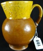 Ewenny Pottery; a late 19th Century brown and yellow jug having sgraffito marks to base ‘Ewenny