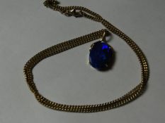 A nine carat gold link pendant chain with an oval blue opal style pendant, 8 grms gross.