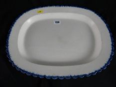 Circa 1830 pearlware platter with blue wavy moulded feather edge, impressed mark to base ‘Baker