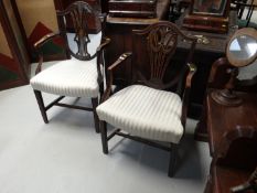 Two Hepplewhite style mahogany shieldback dining armchairs on square front tapered supports and ‘