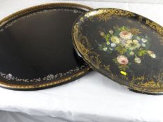 A Victorian black papier mache floral decorated oval tray and a similar oval tray, each damaged.