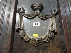 A small gilt wood and gesso wall mirror, the frame of tied drapery with a coronet cresting, 9 ins