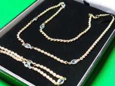 A nine carat gold ensemble of muff type necklace with five oval aquamarines and a matching