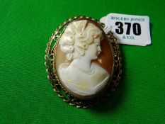 A nine carat gold framed large oval lady’s cameo brooch, frame of triple rope twist and scrolled