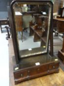 An early 19th Century mahogany swing toilet mirror having a box base with three small drawers on