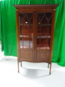 A standing Edwardian inlaid mahogany two door china cabinet, 35 ins wide.