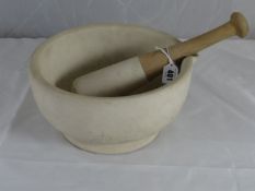 A large stoneware pestle and mortar, 10 ins diam.