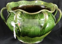 Ewenny Pottery; an eight-handled green glazed jardinière having wavy rim and mark to the base ‘