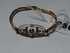 A yellow metal oval double band seed pearl and pink stone decorated bracelet with expanding links.