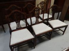 A set of six 19th Century mahogany Hepplewhite style dining chairs with shaped centre splats and
