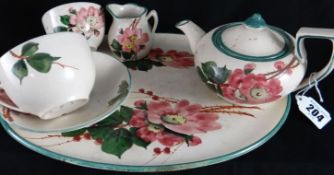 Llanelli Pottery; a rare early 20th Century cabaret set including tray, teapot, cup and saucer,