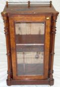 A mid Victorian figured walnut single door sheet music cabinet having a brass gallery rail to the