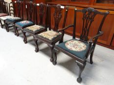 A set of four Chippendale style mahogany chairs with drop-in floral tapestry seats together with
