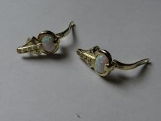 A pair of nine carat gold opal and cz earrings.