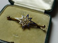 A fifteen carat gold and blue enamel bar brooch with centre seed pearl decorated star, total 5