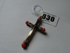 A yellow metal crucifix with coral arms and centre seed pearl.