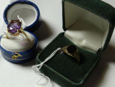 A nine carat gold oval agate signet ring and a nine carat gold dress ring with large oval purple