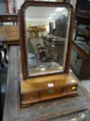 An 18th Century mahogany swing toilet mirror having a parcel gilt frame and with a box base having