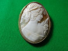 A pinchbeck framed oval lady cameo brooch in a fine stepped wavy frame, cameo length 5 cms.
