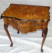 An 18th Century Dutch walnut and floral marquetry lowboy having a serpentine front and having a