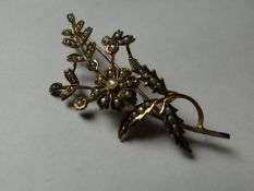 A nine carat gold and seed pearl floral spray pin brooch.