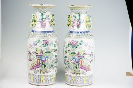 A pair of impressive 18th Century famille rose tall narrow necked baluster vases with twin