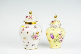 An early 20th Century Dresden yellow ground floral decorated vase with knopped and domed cover;