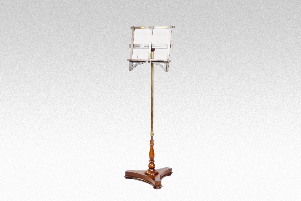 A brass column music stand on a shaped mahogany platform base.