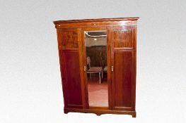 An Edwardian mahogany and inlaid triple wardrobe with centre bevelled mirrored door, 60 ins (153