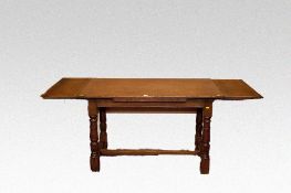 An oblong top oak draw leaf dining table in the refectory style with turned and block corner