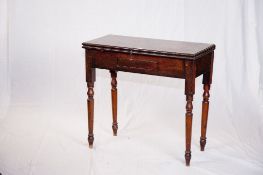 A late Victorian oblong topped mahogany fold over tea table on turned corner supports.