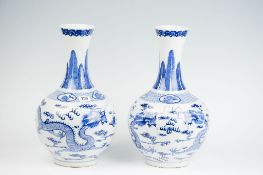 A pair of fine quality late 18th/early 19th Century blue and white narrow necked bottle vases with