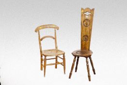 A 20th Century carved oak spinning chair; and a cane seated bedroom chair.