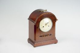 A mahogany encased dome topped bracket clock with eight day striking movement.