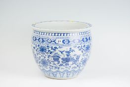 An 18th Century blue and white Chinese fish bowl having prunus blossom and Grecian key banding and