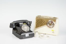 A black bakelite domestic hand telephone; a small bakelite encased KB portable radio; and a pair