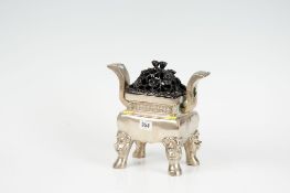 An early 19th Century polished bronze oblong Chinese censer having corner mask supports and with a