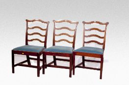 A set of six mahogany Chippendale style dining chairs having triple shaped ladderbacks, wide drop in